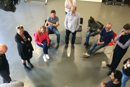 Image of Graeae team and participants in a circle talking