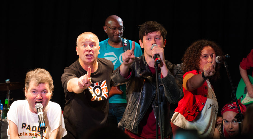 Image of cast on stage from Reasons to be Cheerful
