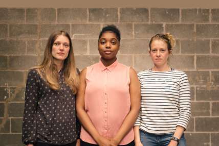 A photo of Genevive Barr, Lara Steward and Alexandra James, all standing against a brick wall looking straight to camera.